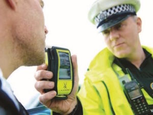 Policeman testing motorist for drink-driving