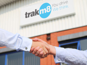 Handshake with Trakm8 logo