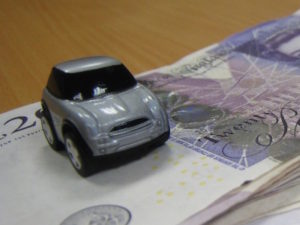 Toy car on pile of money