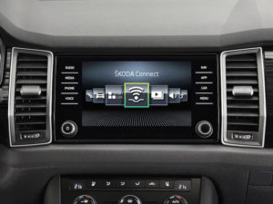 Car dashboard showing screen with Skoda Connect services logo