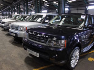 Row of SUVS with blue Range Rover in foreground