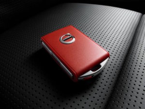 Volvo red key on black leather car seat
