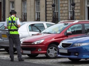 Civil enforcement officer giving parking fine