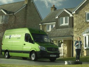 Green TyresOnTheDrive van outside a house