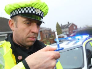 Police officer testing for drug driving