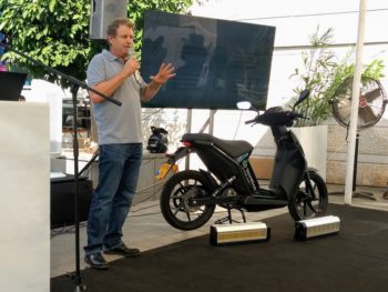 Dr Myersdorf, CEO and founder of StoreDot, with the Torrot Muvi electric scooter featuring StoreDot's prototype ultra-fast charge battery